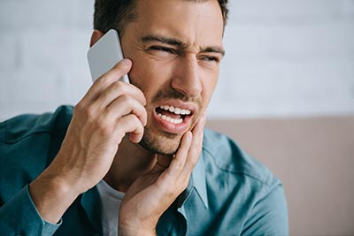man calling an emergency dentist in Hayden, ID